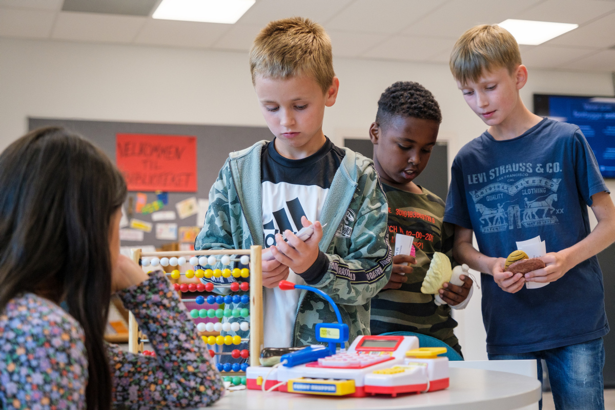 Children at school in Oslo, pretending to shop and pay with money