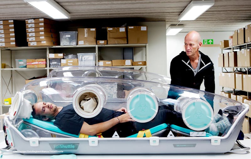 Man inside an EpiShuttle, an isoluation unit by Epiguard. Health tech company Oslo