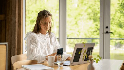 Woman working remote on a computer Fredrik Ahlsen Visit Norway